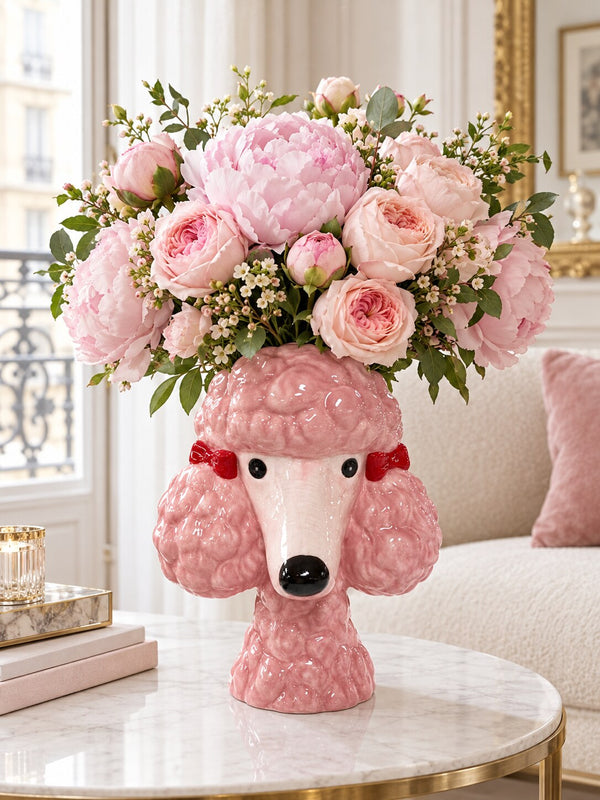 Benjita pink poodle head vase filled with peonies and roses on a marble side table