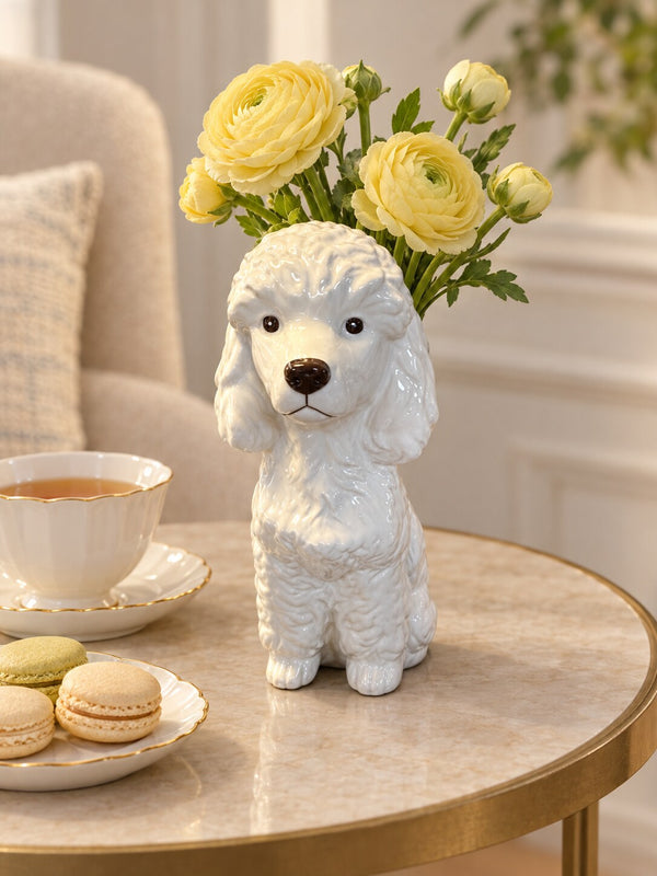 Caniche white poodle dog vase with yellow ranunculus on a side table