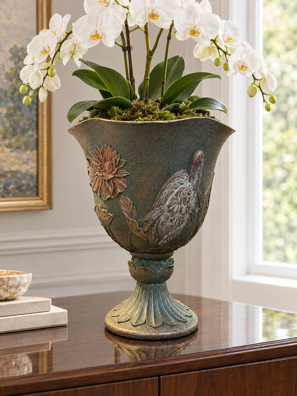 Casa dark green grey crane planter with a white orchid on a sideboard