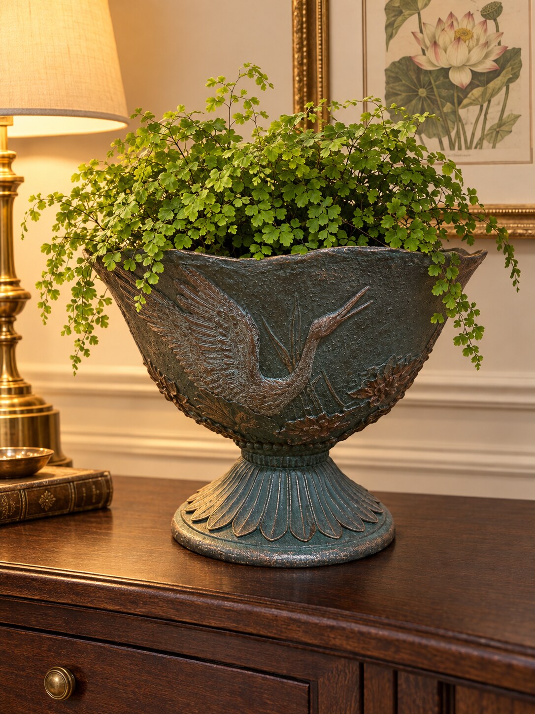 Hacienda footed urn planter with crane relief and maidenhair fern on a hallway console