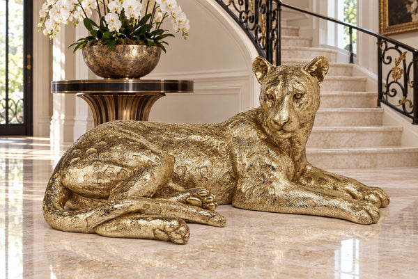 Leopardo large gold leopard statue in a luxury entrance foyer with orchids