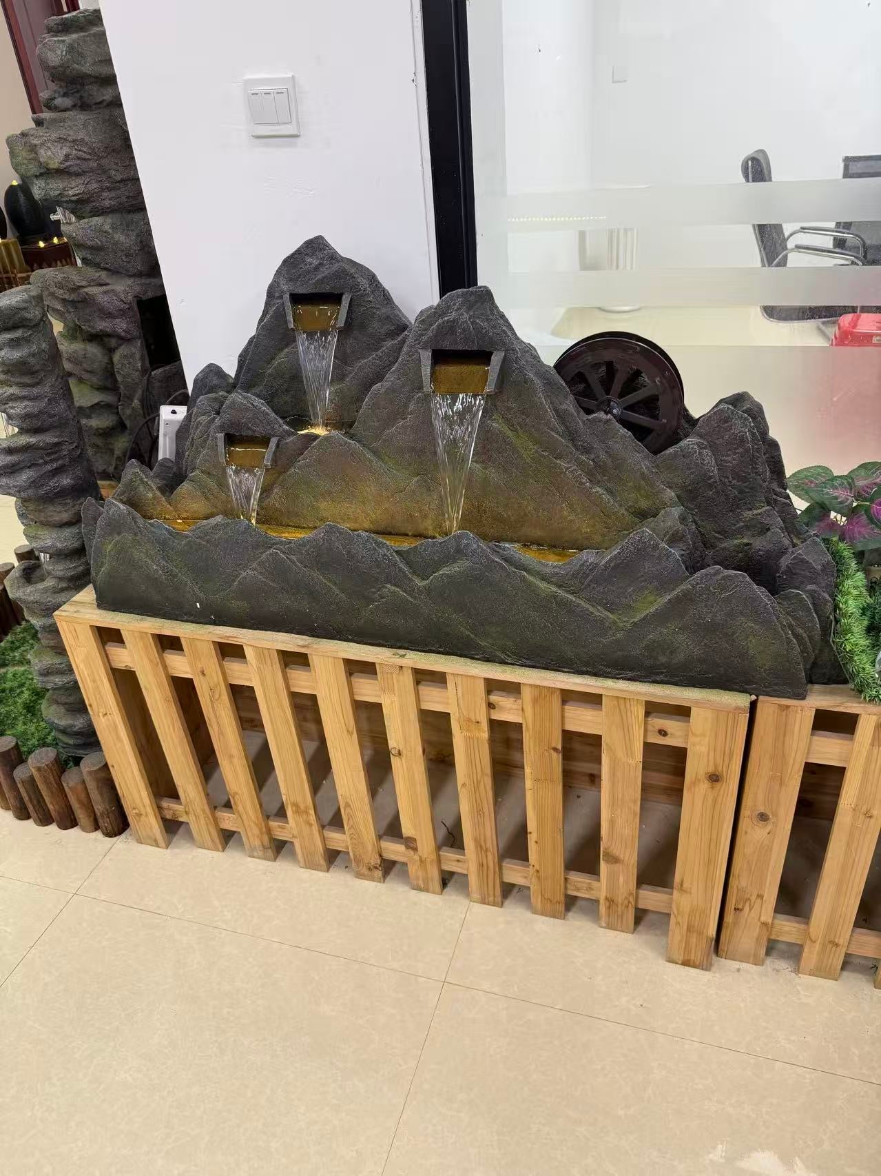 Montagne mountain-shaped fountain with water wheel