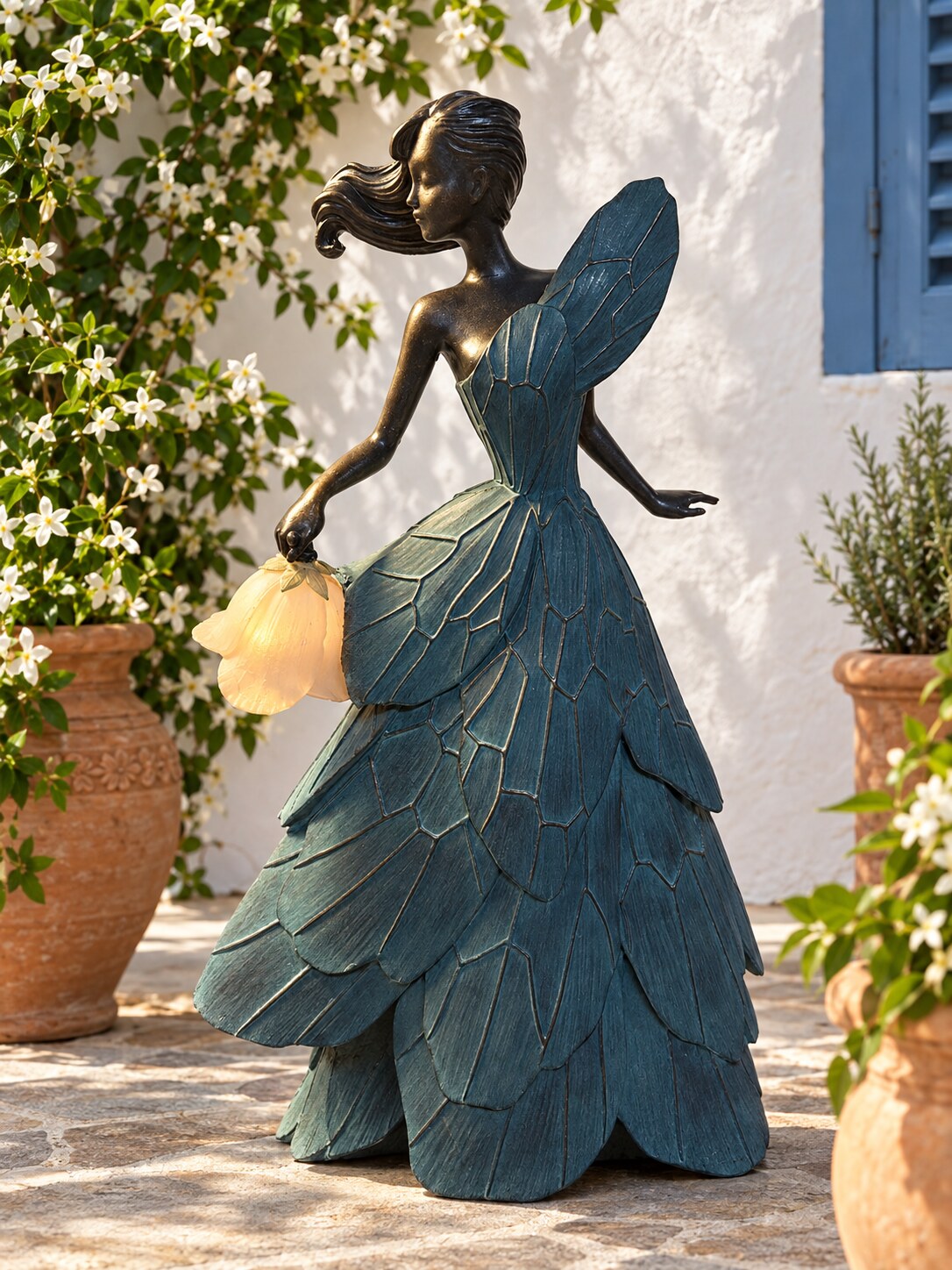Bianca bronze and blue resin lady statue with tulip lantern in a Mediterranean courtyard