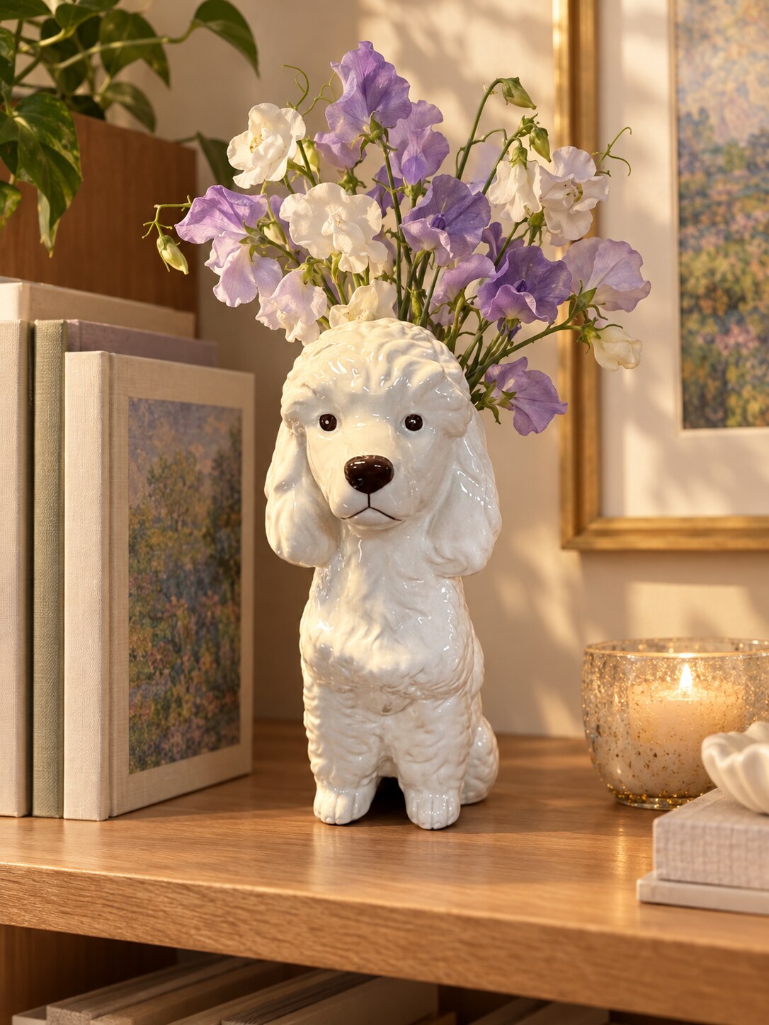 Caniche white dolomite poodle vase with sweet peas on a bookshelf