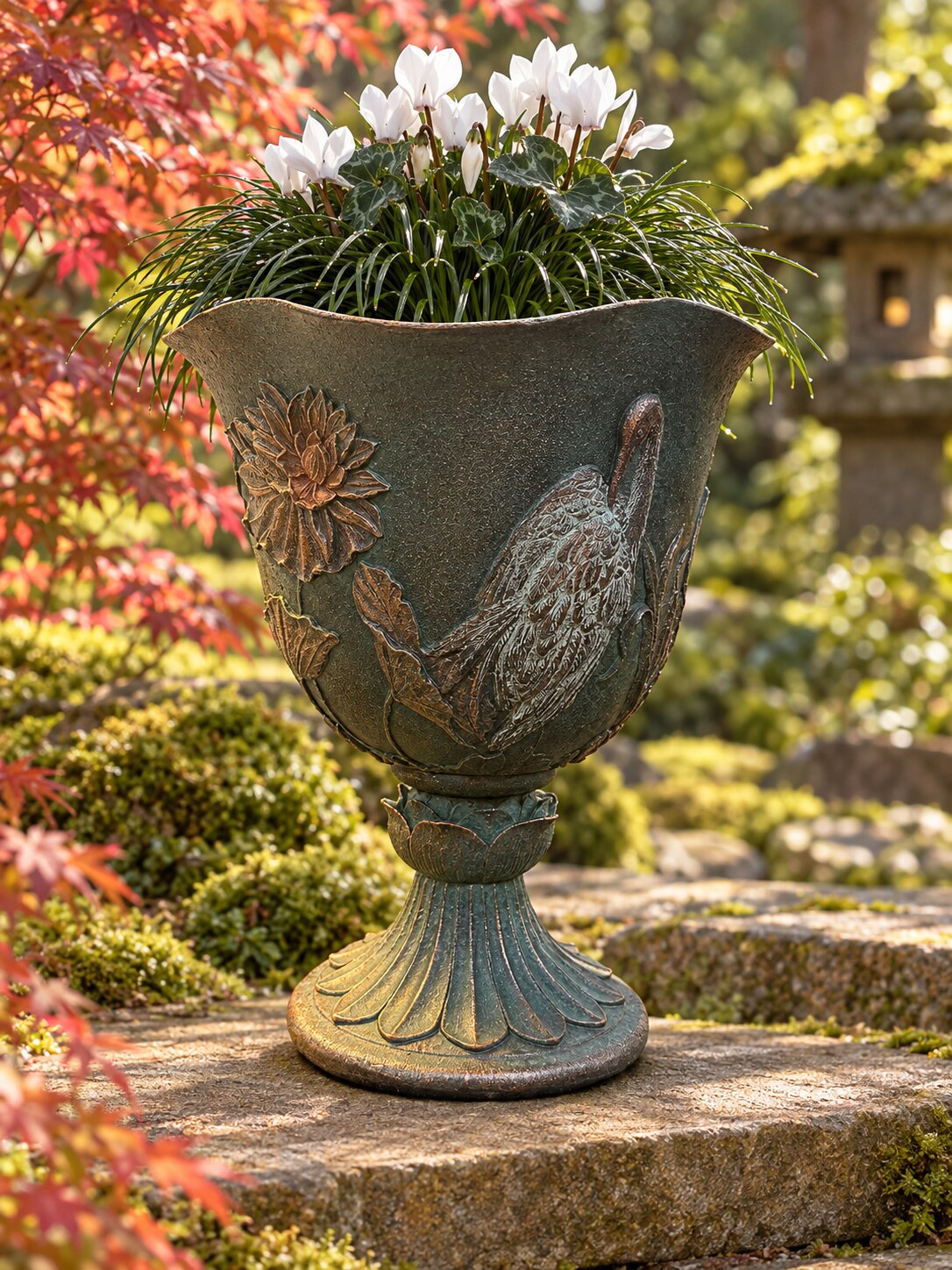 Casa crane bird goblet planter in dark green grey with cyclamen in a Japanese-style garden