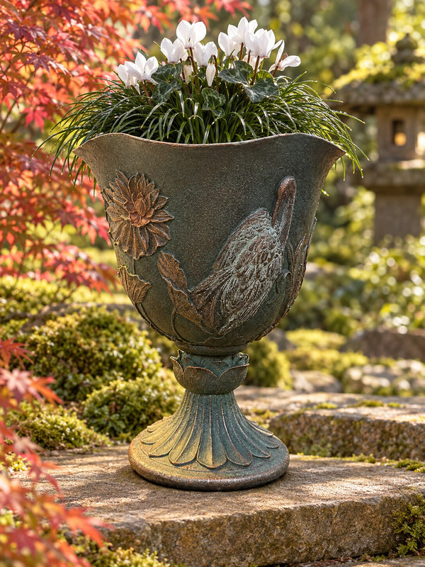 Casa crane bird goblet planter in dark green grey with cyclamen in a Japanese-style garden