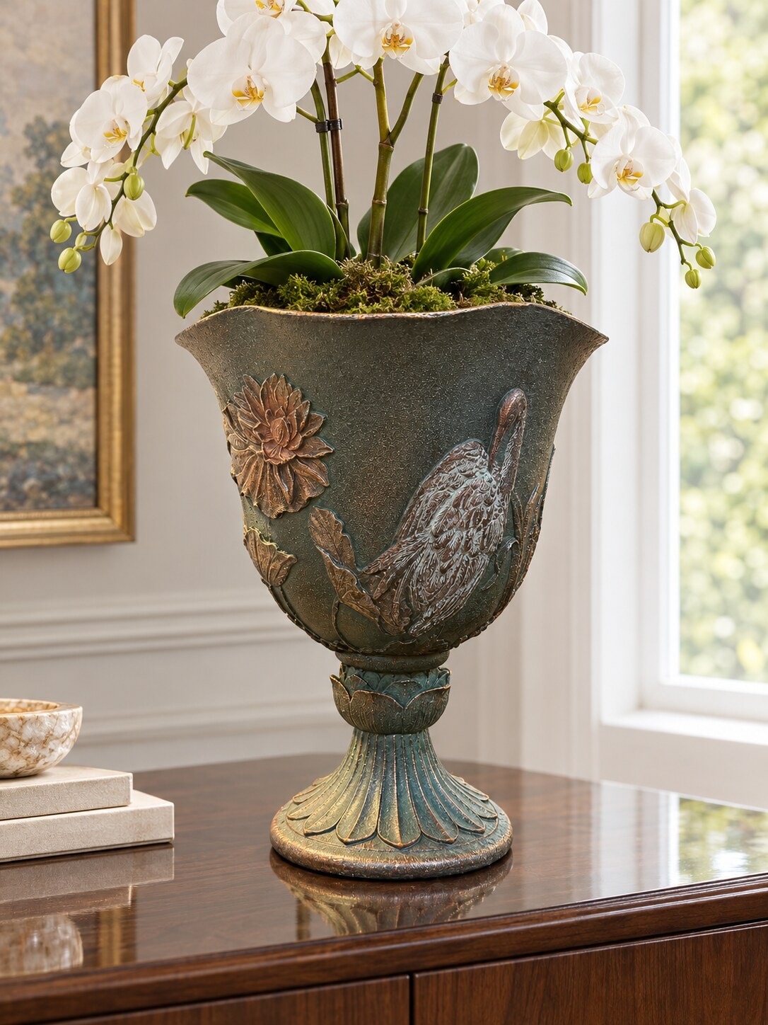 Casa dark green grey crane planter with a white orchid on a sideboard