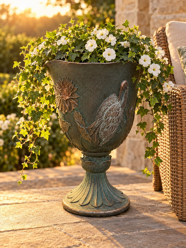 Casa crane goblet planter with cascading ivy and petunias on a stone patio