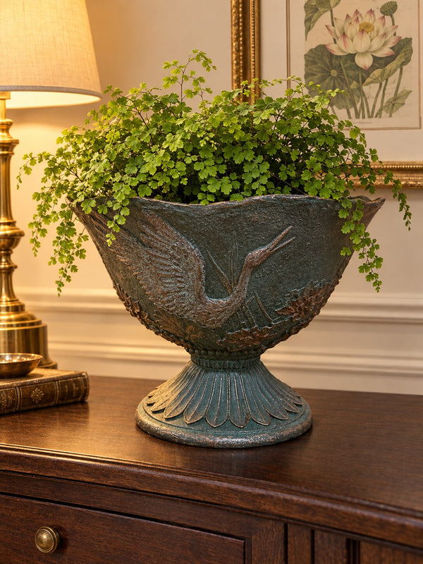 Hacienda footed urn planter with crane relief and maidenhair fern on a hallway console