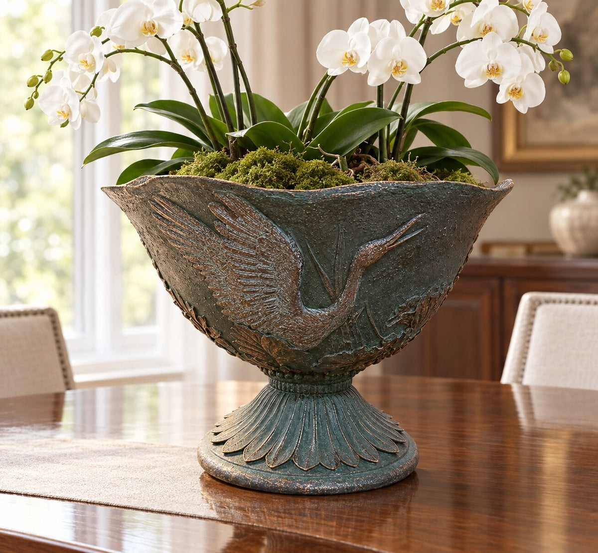 Hacienda dark green grey crane planter with white orchids as a dining table centrepiece