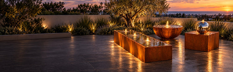 Corten steel water features on a rooftop terrace at sunset