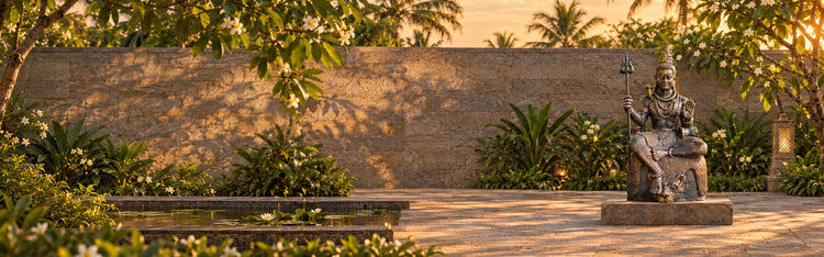 Mahadev seated Lord Shiva statue in a temple garden at golden hour