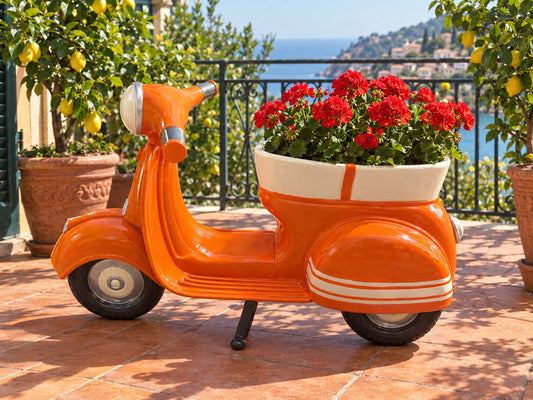 La Traviata orange vintage scooter planter with red geraniums on a Mediterranean balcony