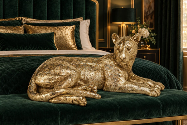 Leopardo gold reclining leopard on a velvet bench in an emerald bedroom