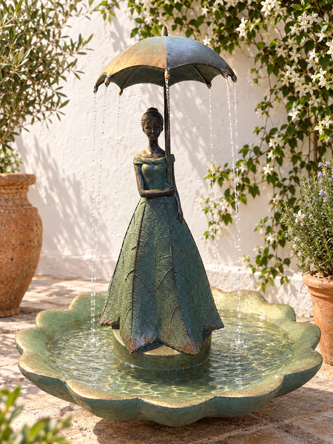 Paraguas umbrella lady water fountain in a Mediterranean courtyard with jasmine