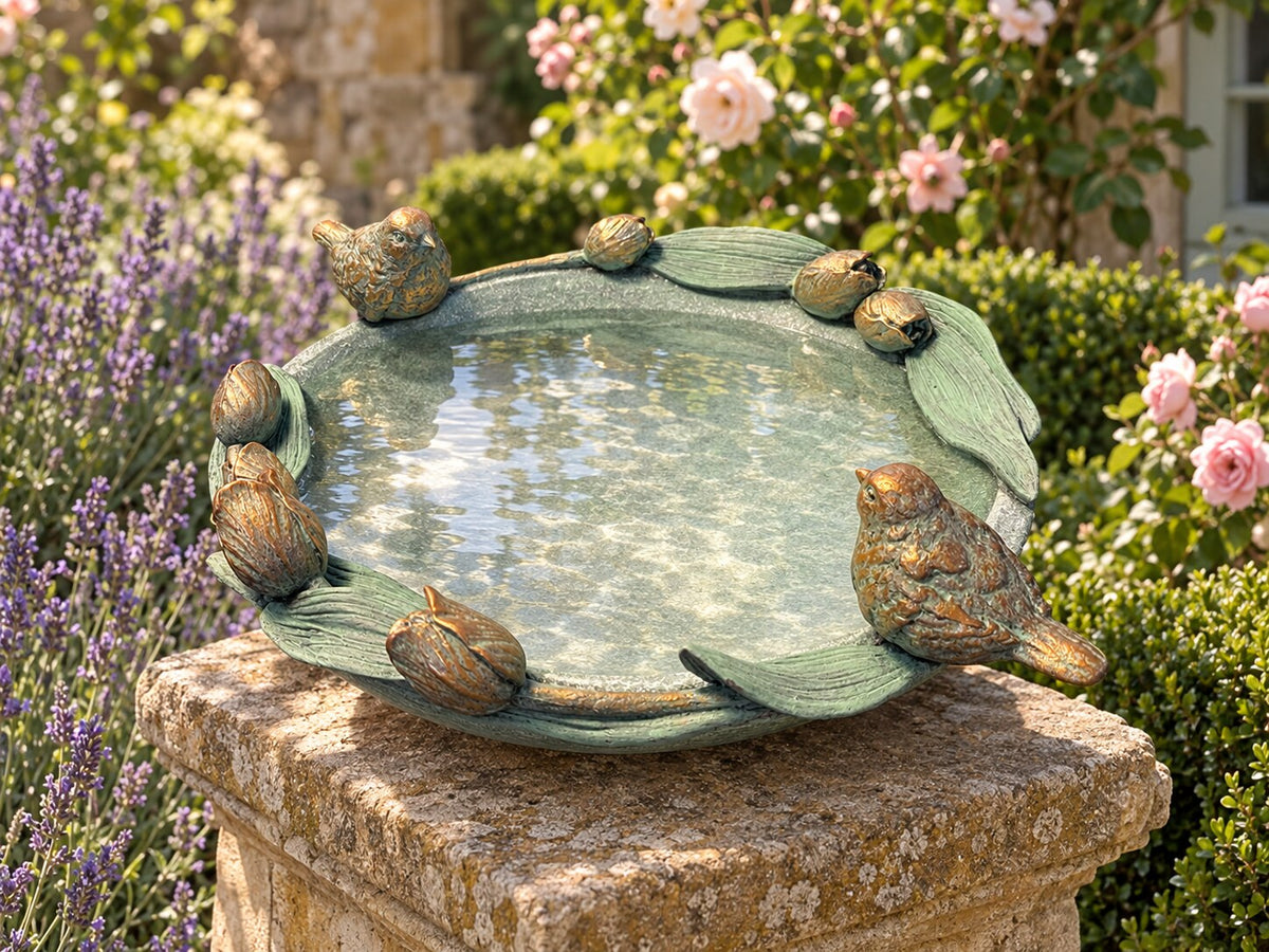 Volare tulip bird bath on a sandstone plinth in a cottage garden