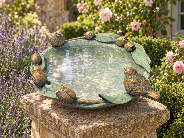 Volare tulip bird bath on a sandstone plinth in a cottage garden